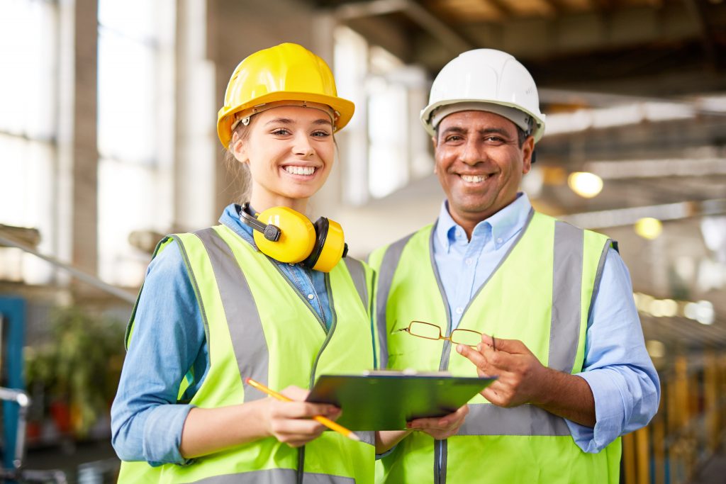 Young and mature engineers Experienced engineer with a young female trainee