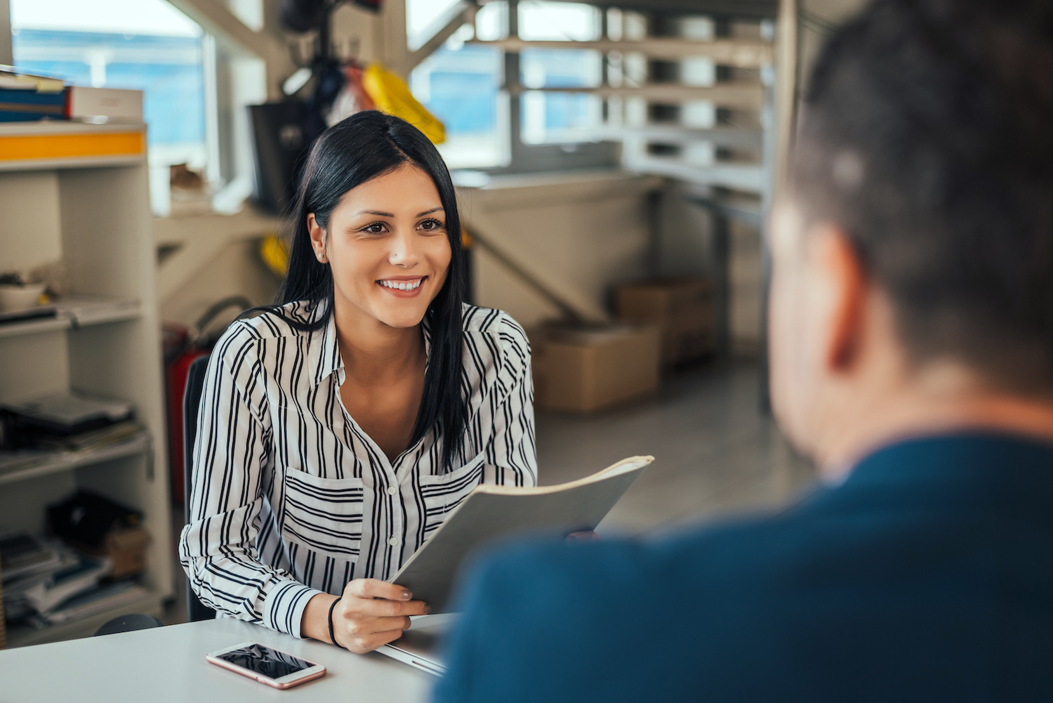 Woman consultant talking with client in office. Woman consultant talking with client in office.